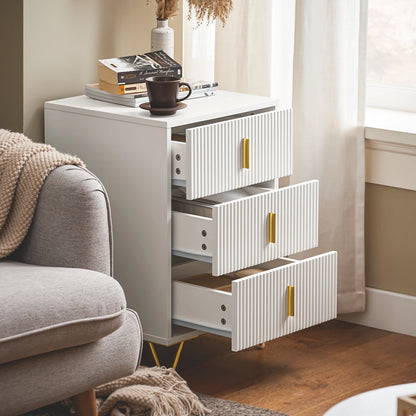 table de chevet blanche avec 3 tiroirs ouverts dans un salon design